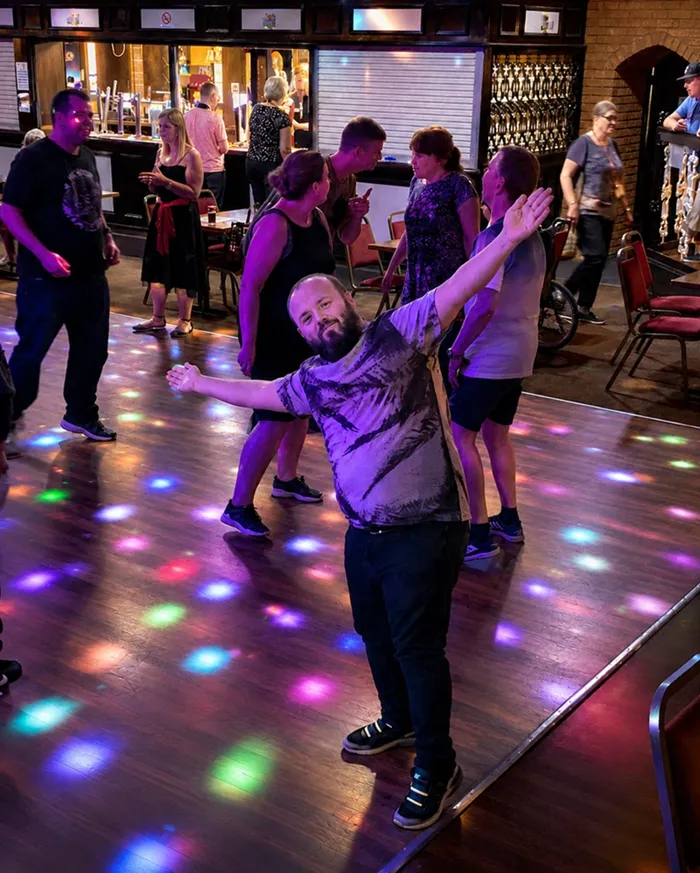 A group of people are dancing at a disco