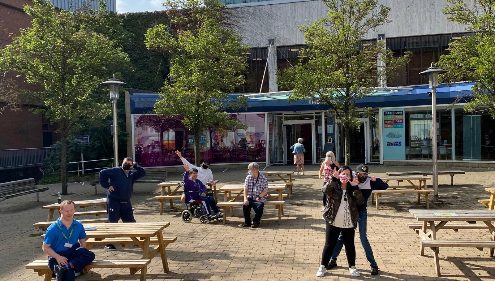 A group of people are outside enjoying the sunshine