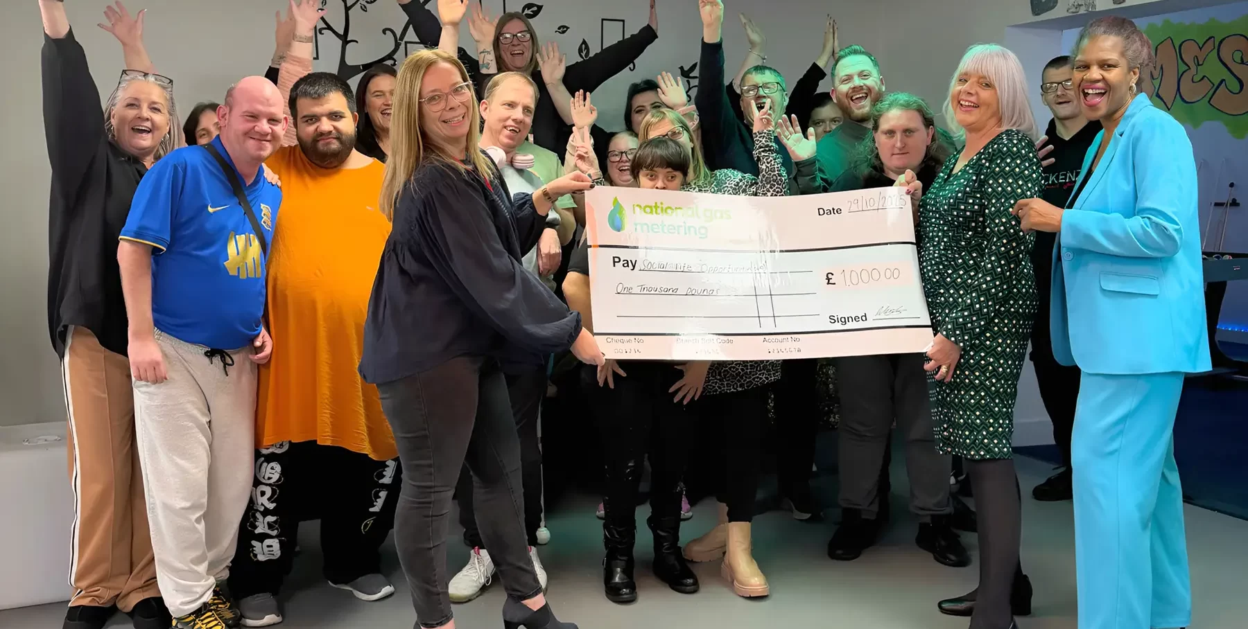 National Gas Metering donating a cheque to Social Life Opportunities