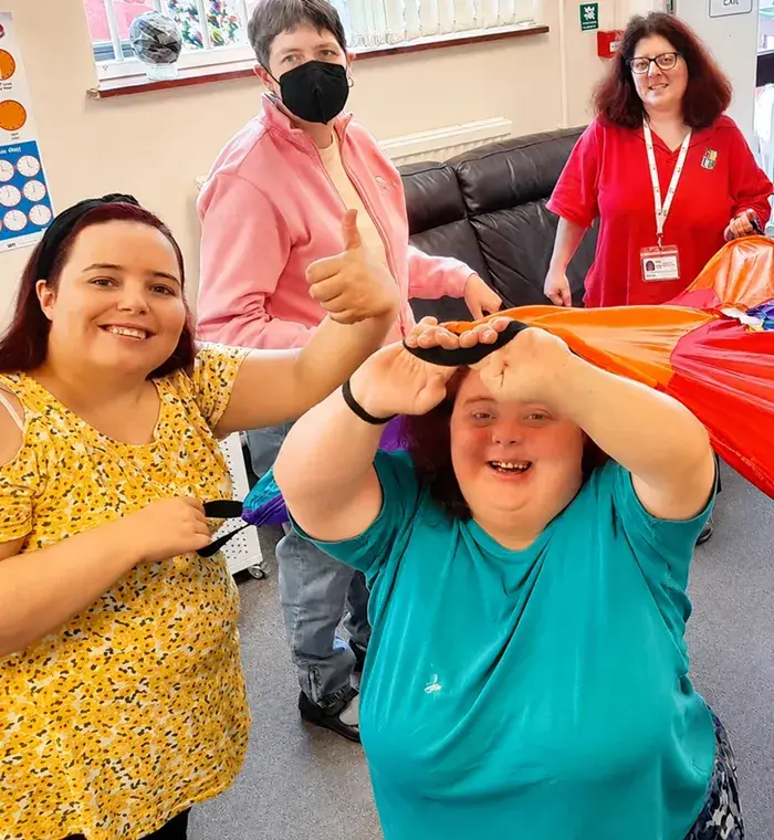 adult service users smiling and playing