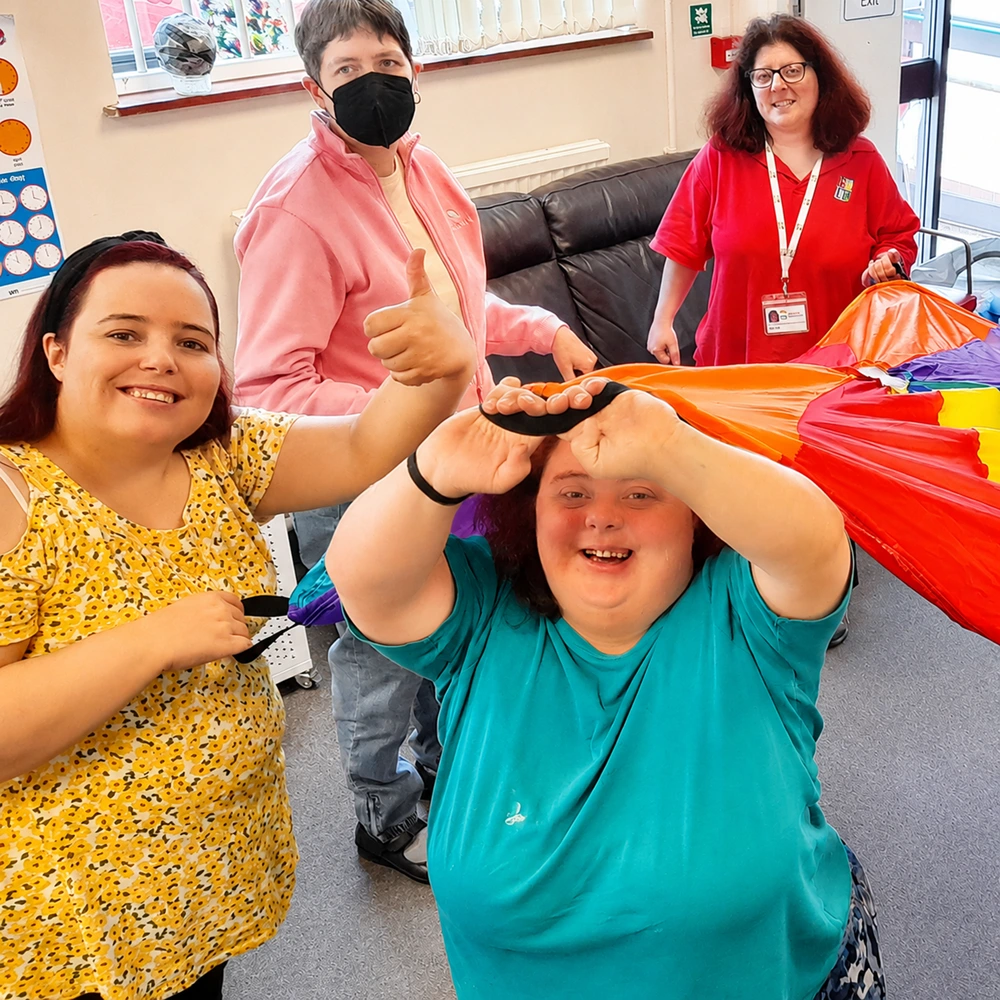 adult service users smiling and playing