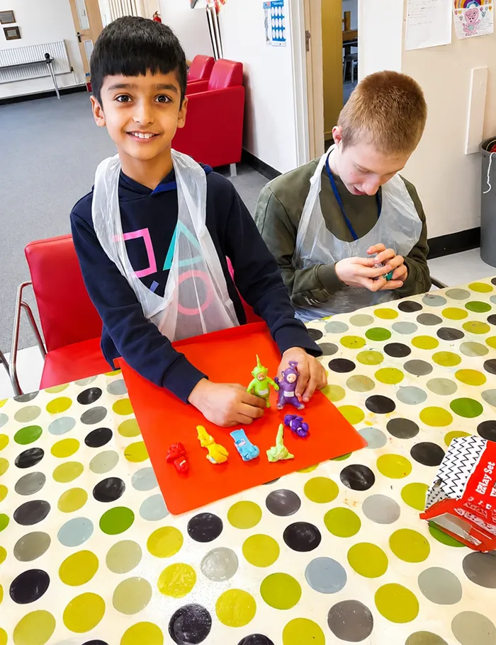 child playing and smiling at the camera
