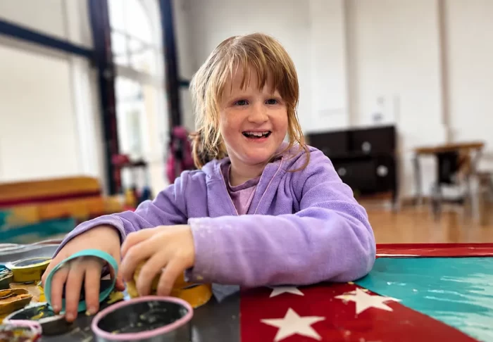 Little girl playing with toys and smiling