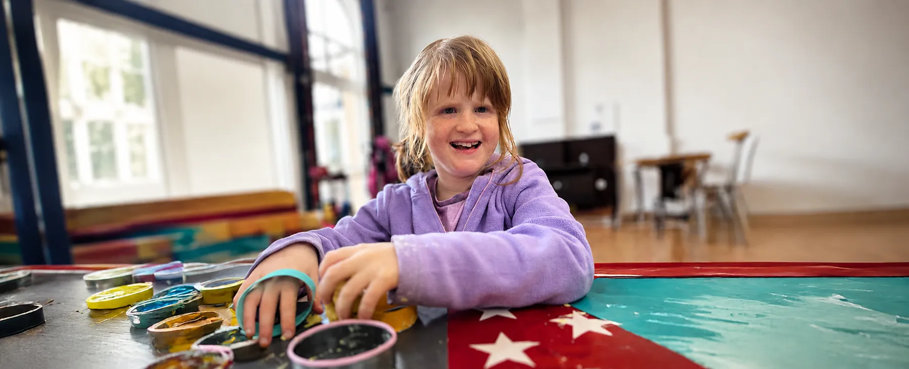 Little girl playing with toys and smiling