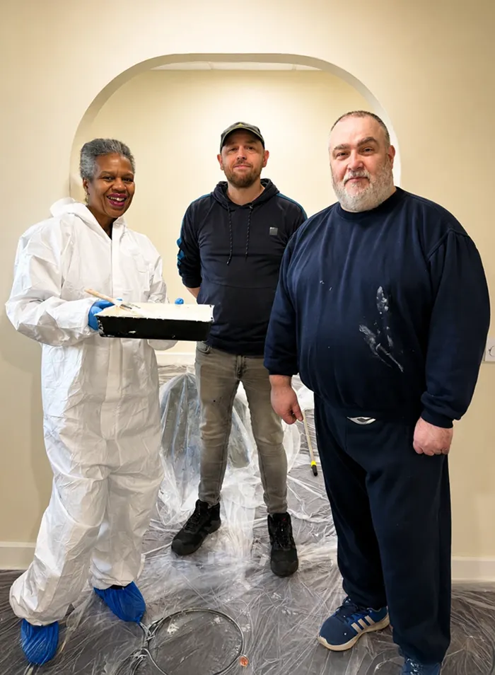 Volunteers from National Gas painting the walls at SoLO's Walnut House