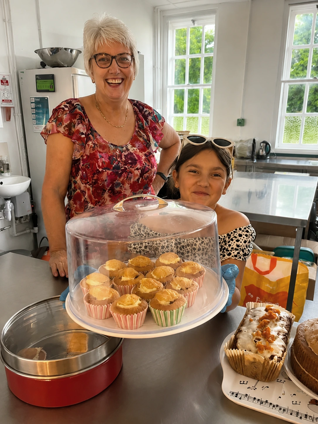 Volunteers selling homemade cakes at an Afternoon Tea fundraising event for SoLO